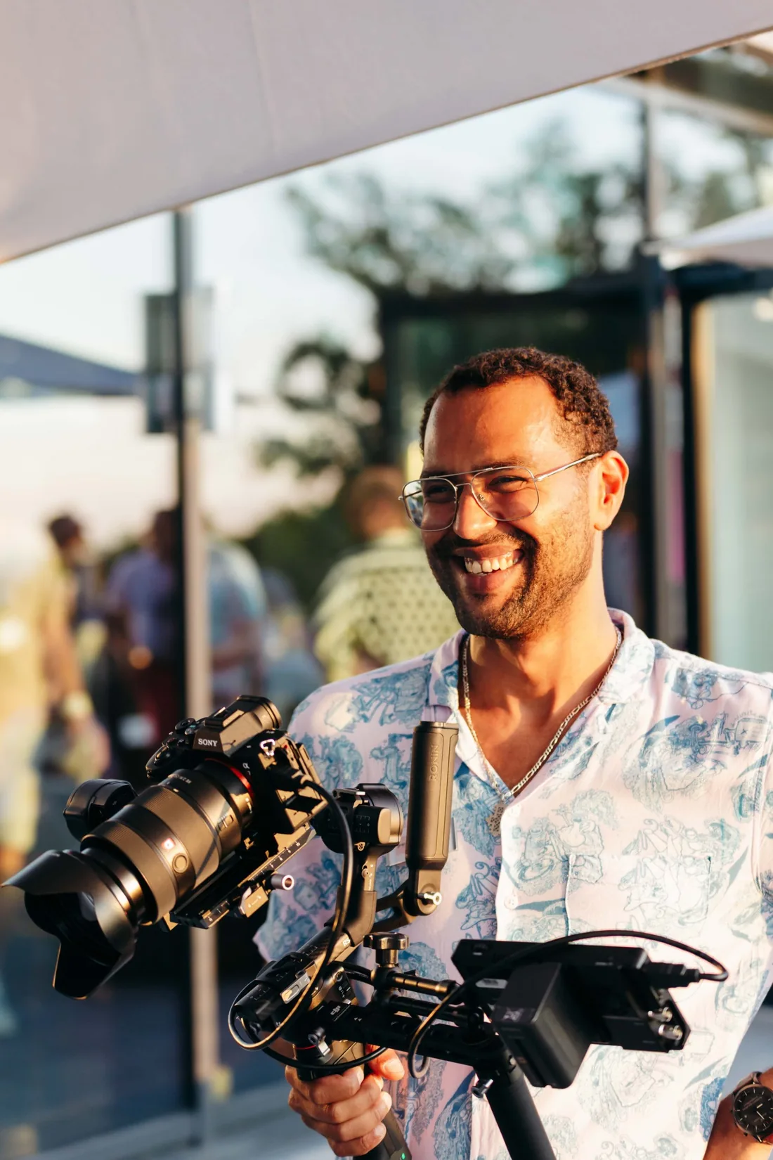 Lukas Gautsch lacht hinter einer Kamera auf einem Gimbal